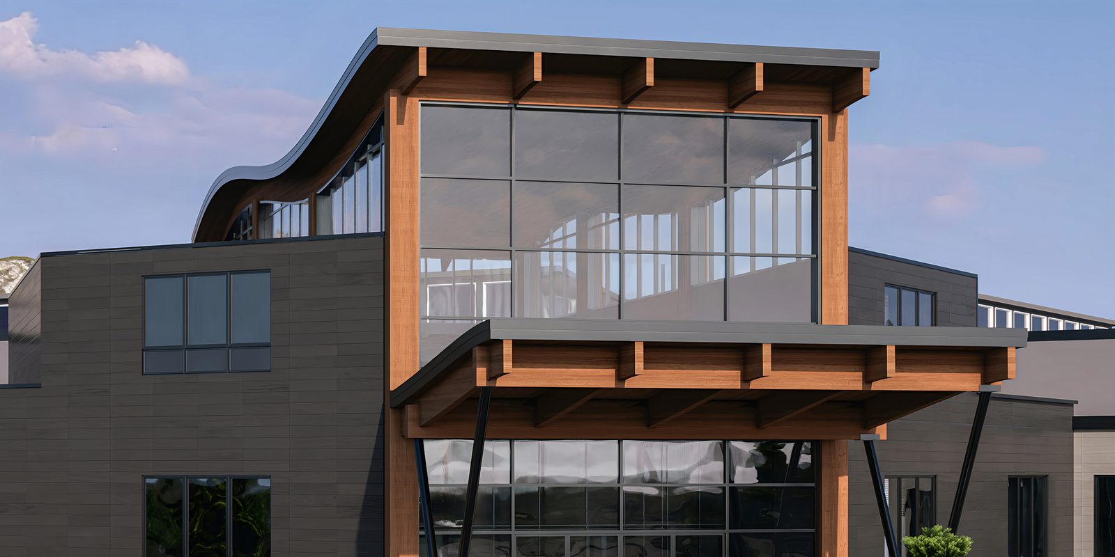The main entry canopy — heavy timber beams on angled steel supports, sheltering the glass front doors.
