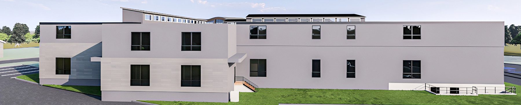 The rear of the building: two storeys of apartment windows facing a lawn.